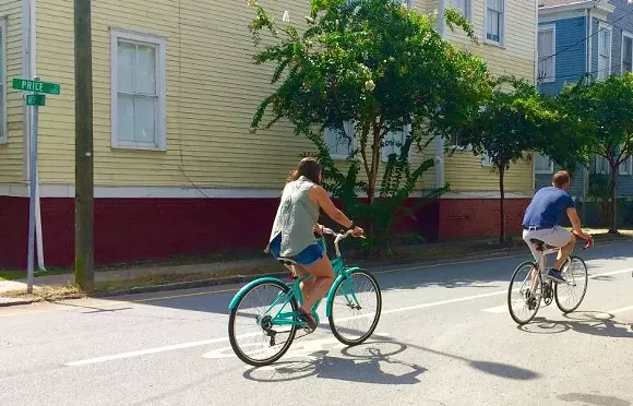 What did drivers get when their ability to travel 20 mph above the speed limit was curtailed by the Price Street bike lane? A safer street.