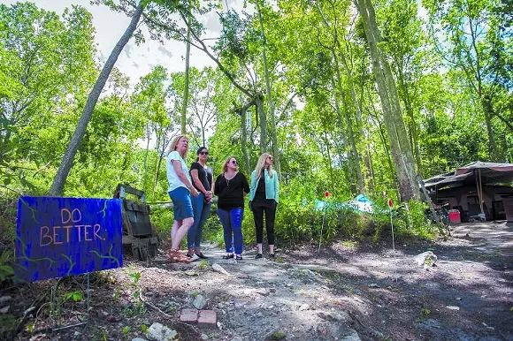 Below: Homeless Authority director Cindy Kelley surveys the site with fundraising partners Meredith Sutton, Sarah Shartzer and Lori Judge. - PHOTO BY JON WAITS