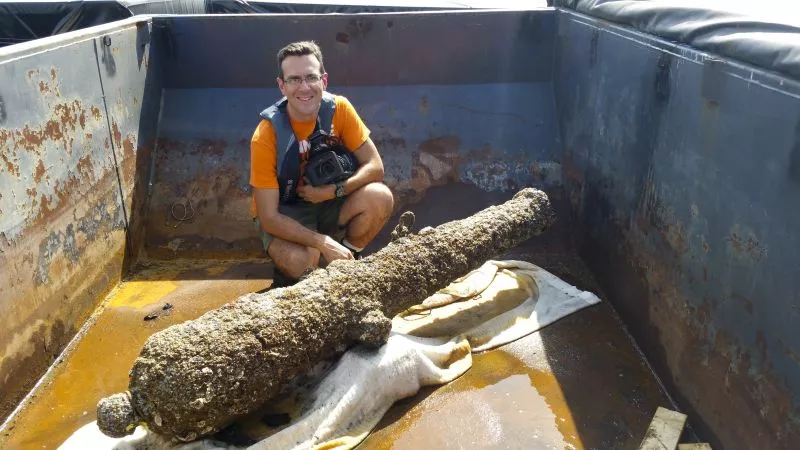 Filmmaker and historian Michael Jordan with one of the CSS Georgia's 32-pounder cannon (the 32 pounds refers to the weight of the shot fired, not the cannon)