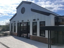 The renovated facade of the old machine shop, now a spacious meeting and event space.
