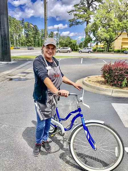 Frances, a bike recipient, received a bike, helmet and safety materials to help her get to her job.