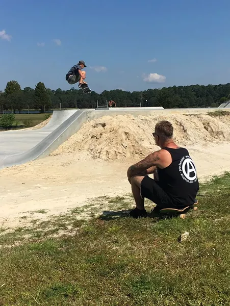 Maher watches Justin Kesler catch air over one of the park's basins. - JESSICA LEIGH LEBOS