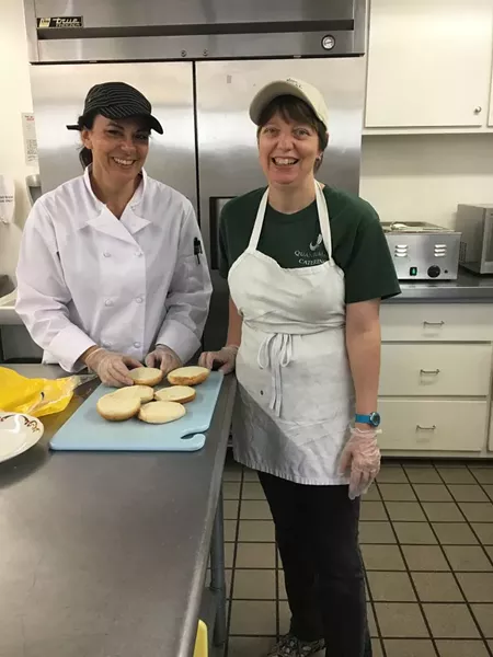 Chef Angie Real (l.) and staff member Jill Adelman prepare box lunches for a corporate client.