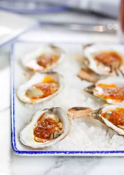 Roast Barbeque Oysters are crowned with bourbon smoked jalapeno butter