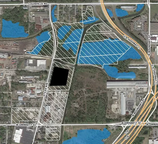 Map of City-owned parcels at site (white hatching) with wetland areas identified (blue). Map by author