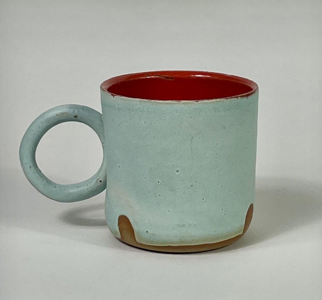 Ring mug of wheel thrown brown stoneware with an aqua matte and poppy gloss glaze.