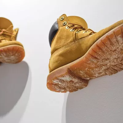 Artist Nikki Zuaro's work boots are displayed as part of her (f) Utility exhibition at the Cedar House Gallery.