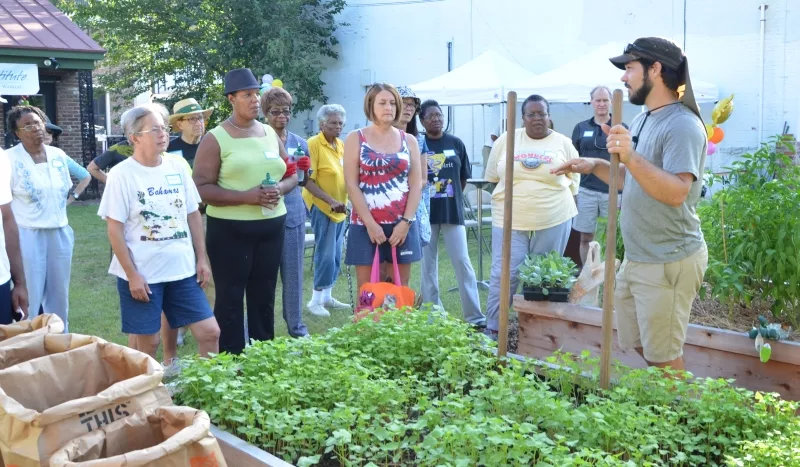 Victory Gardens co-owner Kerry Shay explains the process of changing from one planting season to another. Photo by James Byous, © Canyon Ranch Institute.