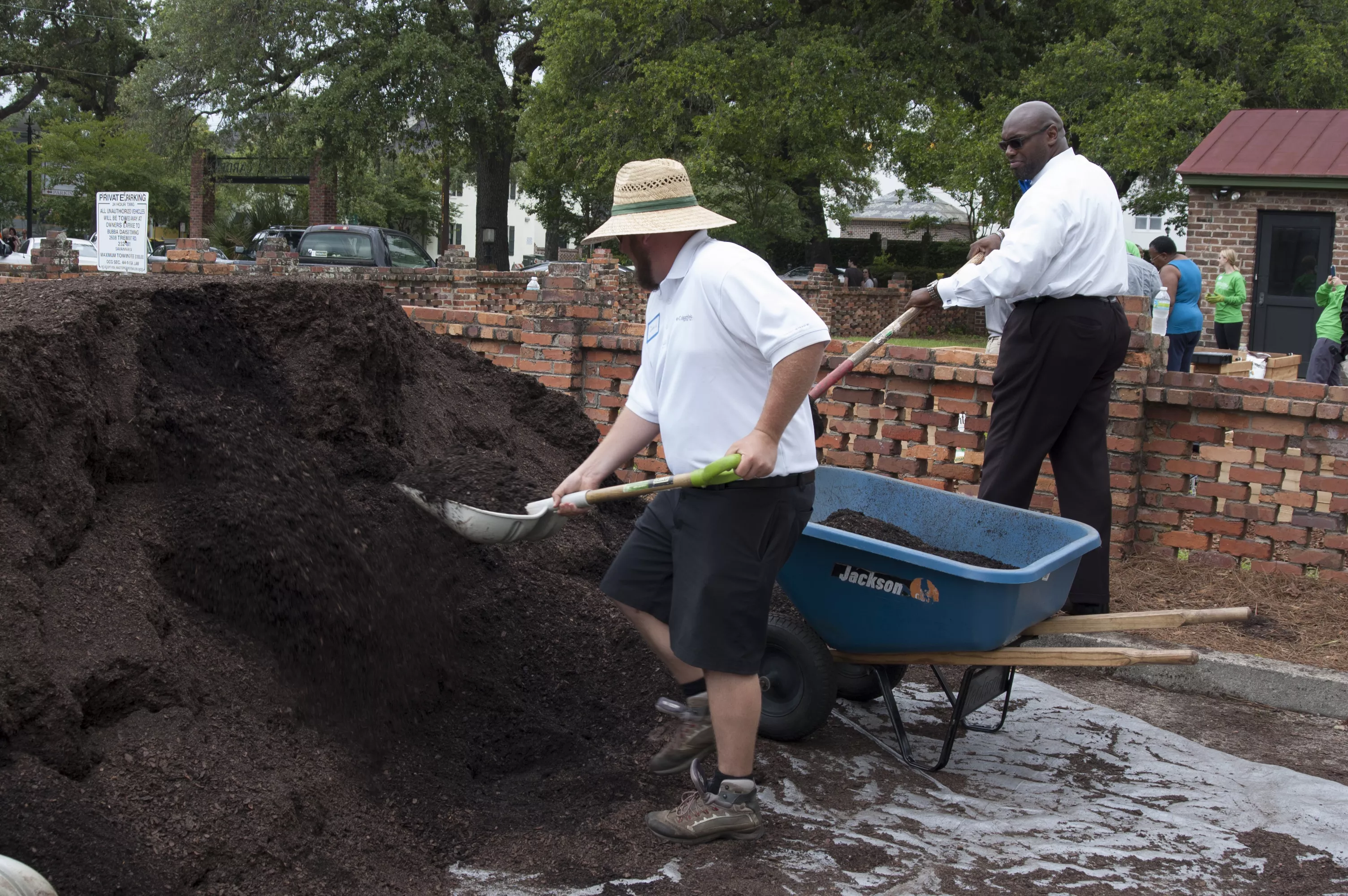 Victory Gardens' David Hislop moves soil to the raised garden beds with the help of C. MeGill Brown, pastor of Second African Baptist Church, Savannah Police Department Chaplain, and president of Curtis V. Cooper Primary Health Care's Board of Directors.