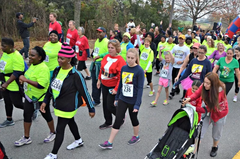 Walking Club participants (in the bright green T-shirts) from the CRI Life Enhancement Program with Curtis V. Cooper Primary Health Care set out on the Savannah River Bridge Run in December. For many of the Walking Club members, participation in this major community event was a life-time first and came after weeks of training with their CRI LEP exercise professionals. - JAMES BYOUS, © CANYON RANCH INSTITUTE.
