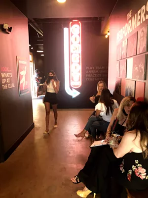 The Dallas Comedy Club's decor includes several nods to the space's previous occupants, like this replication of the Dallas Comedy House's neon sign that has "DCC" letters. - DANNY GALLAGHER