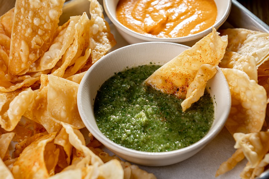 Wonton chips are served with a peanut sambal and a Thai green salsa. - ALISON MCLEAN