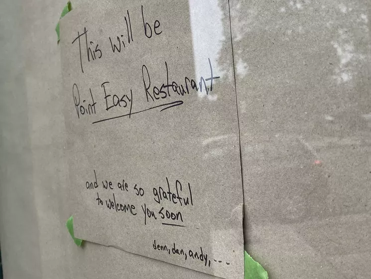 Dennis Phelps has been leaving messages for curious neighbors on the paper-covered door of the old Whittier Pub space. - KRISTIN PAZULSKI