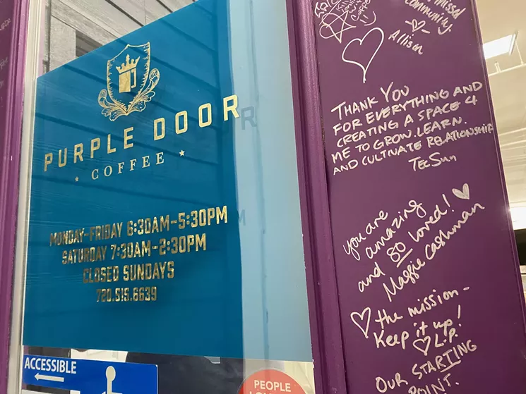 The front door of Purple Door Cafe, covered in notes of love, sits in the small warehouse of Purple Door coffee. - KRISTIN PAZULSKI