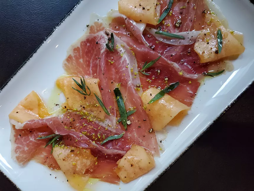 Jamon with local cantaloupe is one example of the seasonal cuisine you can sample at Sunday Vinyl. - MOLLY MARTIN
