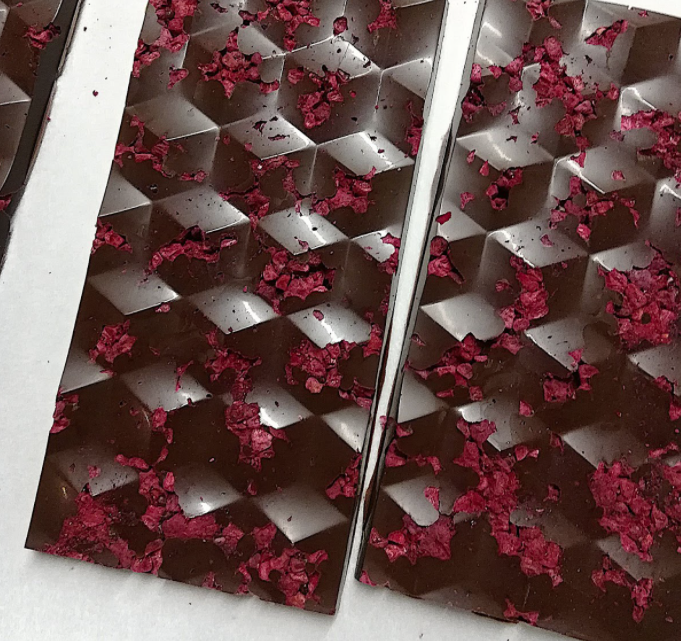 The PBR Bar is made with 55% dark chocolate, natural peanut butter, tart raspberries and sea salt. - BONBON BOMBARDIER