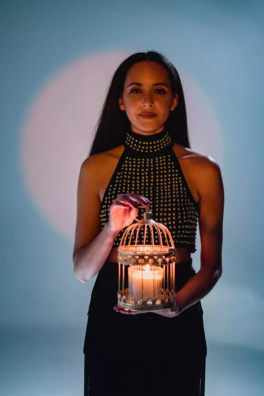 The "Flame" video begins with Bullings lighting a candle, representing the spark that ignites a movement. - MEG MACDONALD