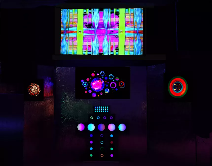 A screen above Lumonics sculptures is illuminated by video produced by Dorothy Tanner and Marc Billard. - MARC BILLARD