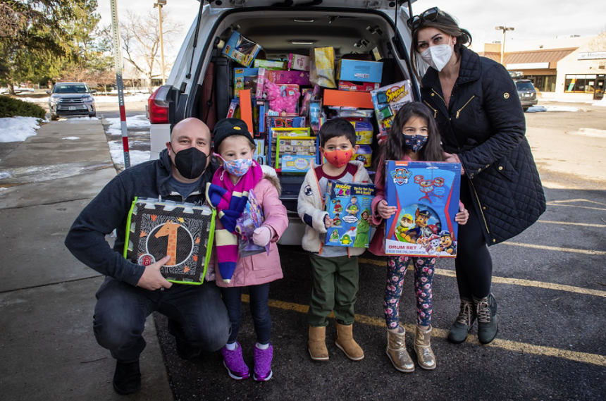 Hosea Rosenberg (left) accepts toy donations.  Many children have donated their Christmas presents to replace the Christmas presents lost in the fire.  - HOSEA ROSENBERG