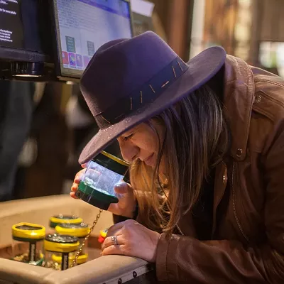 A dispensary customer eyeballs a potential purchase at a Glendale dispensary.