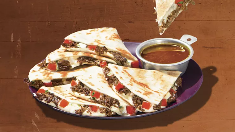 Dip a Taco Cabana quesadilla in a savory birria broth. - PHOTO BY TACO CABANA
