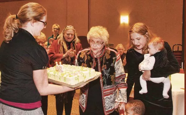 Julianne’s grandson, Robbie, helps GG (Great-Grandmother) blow out her birthday cake candles as his mom, Anne, and his Aunt Ashley look on. Many guests requested the carrot cake recipe. - PHOTO BY HARV KOPLO