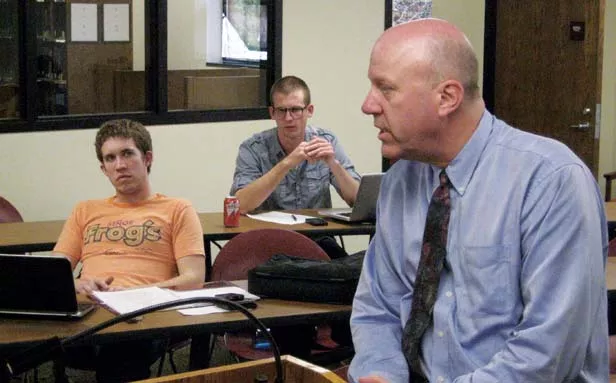 John Hanlon (foreground), legal director for IIP, talks to students who are helping investigate cases. - COURTESY ILLINOIS INNOCENCE PROJECT