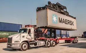 A crane capable of lifting 120,000 pounds unloads a shipping container from a truck at ADM’s Intermodal Ramp, part of the Midwest Inland Port in Decatur. - PHOTO COURTESY ADM