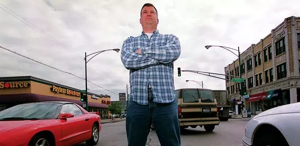 Jerry Marcoccia, who chooses not to own a car for eceonomic and philosophical reasons, stands at the busy intersection of Broadway and Berwyn in Chicago. - PHOTO BY JOHN LEE/MCT