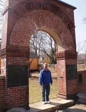 St. James Farms manager Wayne Zaininger beneath the archway from the old William Deering and Company facility.