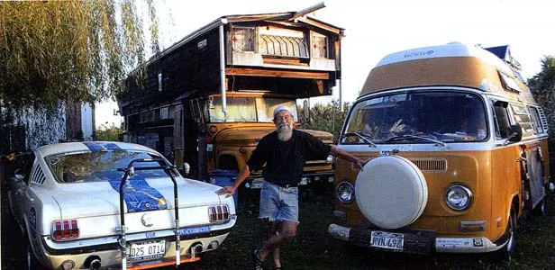 Bob with his beloved vehicles, including the school bus in which he now lives, and his 1972 Volkswagen van, which will go on permanent display at the Rt. 66 museum in Tulsa.