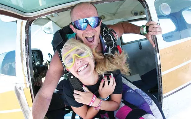 Veteran instructor Brian Meade goes tandem with Emily Eckhoff on her first jump. - PHOTOS BY GREGORY PALMER
