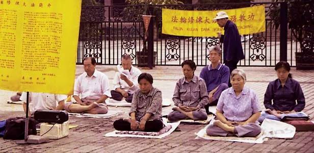 Falun Gong practitioners meditate early one morning in June, 1999, prior to the government crackdown, in front of an art museum in Beijing, China. - PHOTOS BY HILARY SMITH /MCT