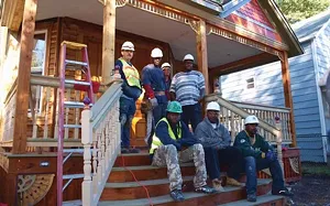 Men from the Urban League’s Male Involvement Program are getting construction training while rehabbing this home on North Fifth Street in the Enos Park neighborhood. Back row, from left to right, are Joseph Yeley, Montrell Isom, Troy Sullivan and S - PHOTO BY DAVID HINE