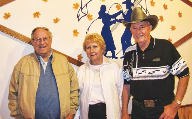 Sharing 25 years of dancin’, smilin’ and livin’: Bill Crawford, left, and Carolyn and DeWayne Crawford helped found the Prairie Land Dance Club in 1987. - PHOTO BY LORRIE EDWARDS