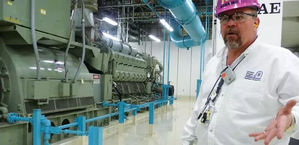 Radiation protection manager Jeff Stovall explains the importance of Clinton Power Station’s backup generators, which can keep the turbines running up to two days in case of a power outage. “This is where we get electrici - PHOTO BY DIANE IVEY