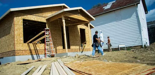 A new home under construction by TSP-Hope sits next to an abandoned property due for demolition. - PHOTO BY PATRICK YEAGLE