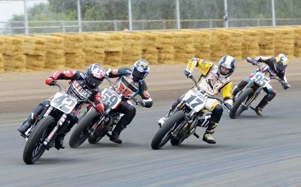 Left feet protected by steel plates called hot shoes, riders lean hard and trust each other as they slide through corners. - PHOTO BY TREVOR MILLER