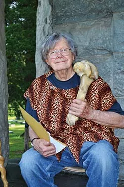 John Knoepfle smiles for the camera with a bone in hand that took 16 hours to cook. - PHOTO BY AMY SPIES
