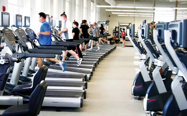 At this time of year, aerobic exercise equipment like these treadmills at the Kerasotes YMCA are in heavy use. - PHOTO BY PATRICK YEAGLE