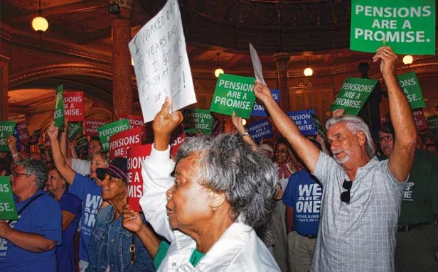Protestors in the Illinois Statehouse fill the Rotunda while rallying against cuts to their pension benefits. - PHOTO BY DAVID HINE