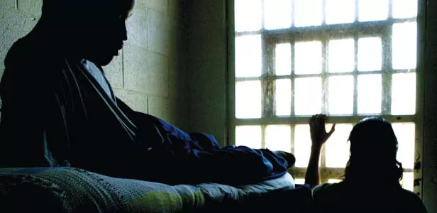 Youths inside their confinement rooms at the Illinois Department of Juvenile Justice Center in Joliet. The facility, formerly under the Illinois Department of Corrections, houses 230 offenders who represent some of the highest risk youths from a securit - PHOTO BY ANTONIO PEREZ/MCT