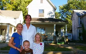 Amber Rigor with her children, Skylar, Kent and Elizabeth, in front of the home she bought from the neighborhood and is restoring on North Sixth Street. - PHOTO BY JOE COPLEY