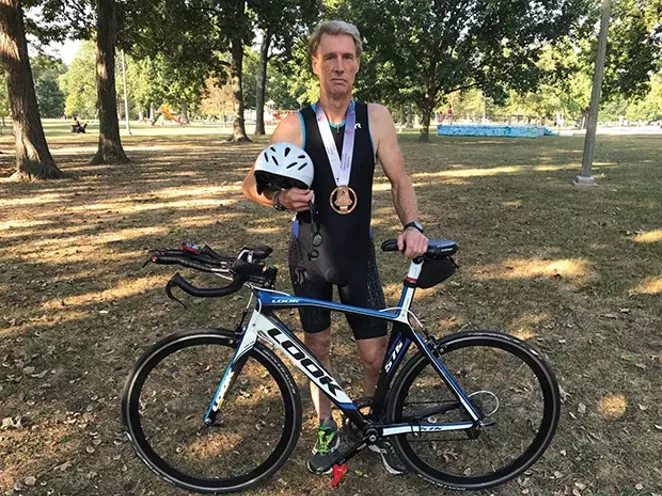 John Williams displays a bronze medal he won at the national Senior Olympics in Birmingham, Alabama for the triathlon event. - PHOTO BY JUDY SHIPP