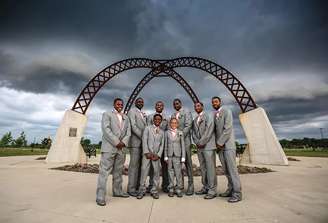 Marcus Bates and his groomsmen fought the storm for some fun photographs at Southwind Park. - PHOTO BY HJS PHOTOGRAPHY