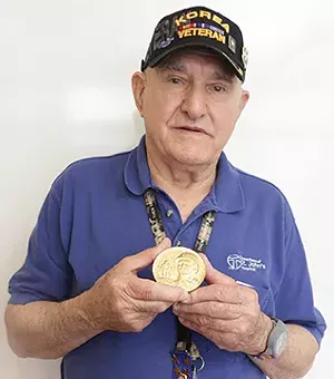 Ivan Maras of Springfield holds his Congressional Gold Medal, awarded to the 65th Infantry Regiment last month.