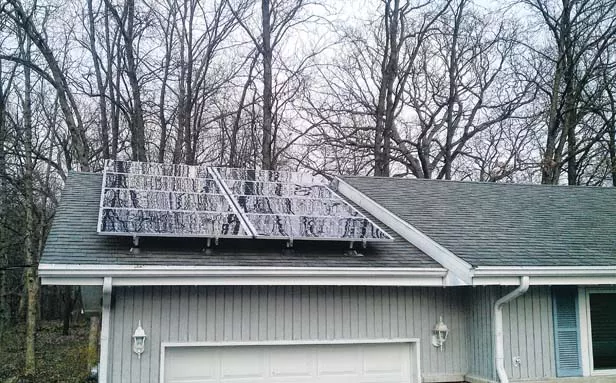 Bob Croteau’s 2-kilowatt solar panel generates enough electricity to run his air conditioner in summer.
