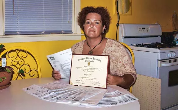 Angela McGonigle with her student loan invoices and the degree the loan financed. A working single mother, McGonigle borrowed $27,000 but now owes $45,000. - PHOTO BY DAVID HINE