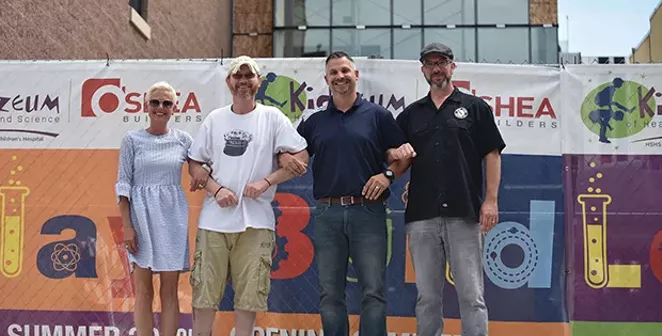 Businesses in the 400 block of Adams Street are eagerly anticipating the scheduled end of July opening of the Kidzeum. From left: Itty Bitty Fashion Truck co-owner Tricia Schlosser, Elf Shelf owner John Michael Combs, Café Moxo owner Mark Forinash, and - PHOTO BY RACHEL JOHNSON