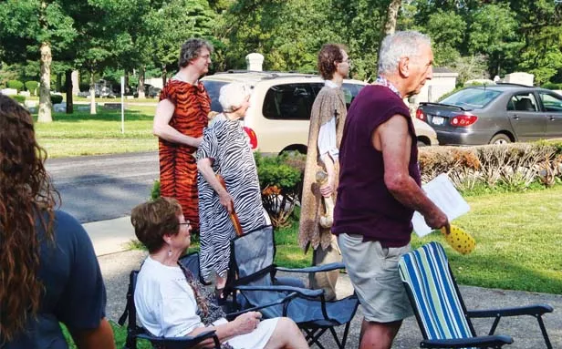 A procession of costumed scholars readies for the ceremony. From left, standing, Brian Jackson, Jackie Jackson, Ethan Lewis and Lou Bosco. - PHOTO BY AMY SPIES